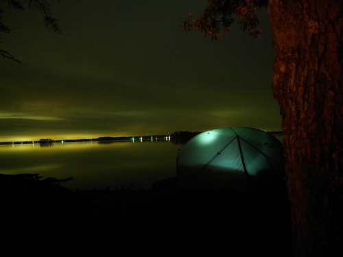 A tent, a tree, a lake.
